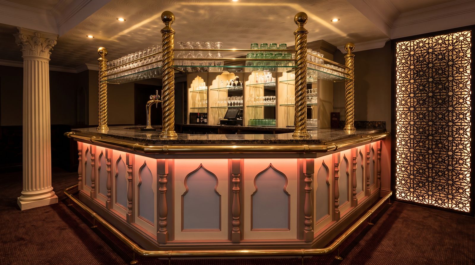 The brass and lacquer bar at Buraq Indian Restaurant, Kirkham, lit warm at night