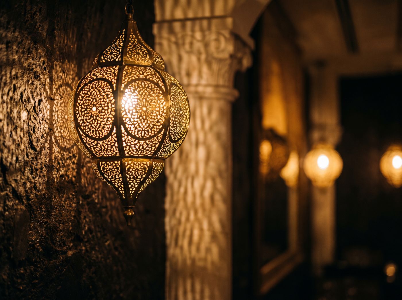 A pierced brass lantern throwing patterned light across the wall at Buraq, Kirkham